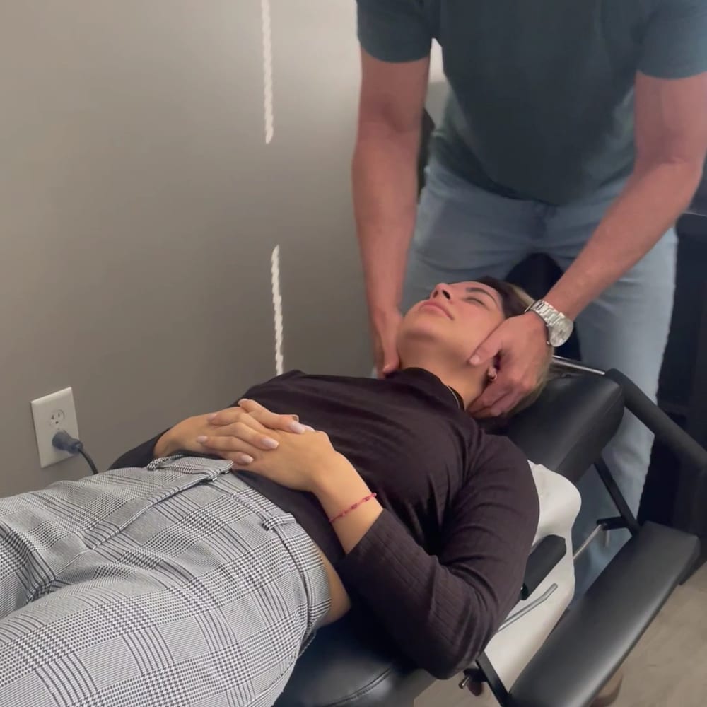 Dr. Currington adjusting a patient’s neck