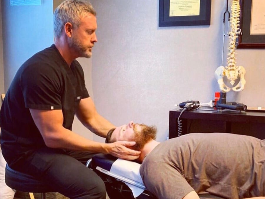 Dr. Currington adjusting a patient’s neck at the clinic